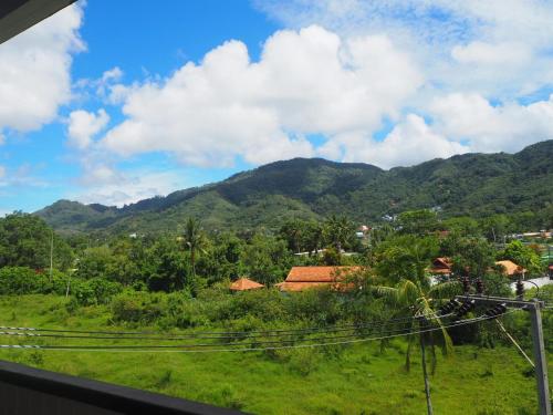 a view of the mountains from a train window at Baan Rosa Bangtao Beach in Bang Tao Beach