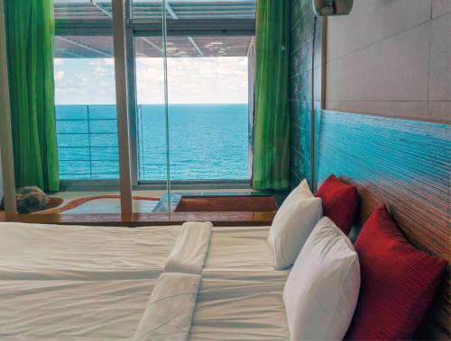 a bedroom with a bed with a view of the ocean at Haslla Art World Museum Hotel in Gangneung