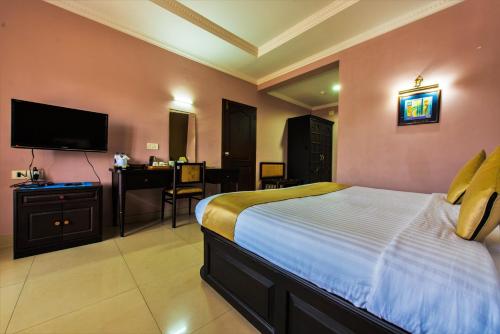 מיטה או מיטות בחדר ב-Kallada Regency