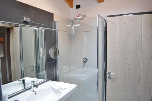 a bathroom with a sink and a shower at Ai Vellutai in Ala