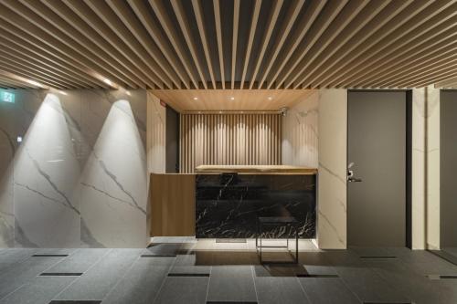 a lobby with a counter and a chair in a room at Kyoto Gion U-BELL Hotel in Kyoto