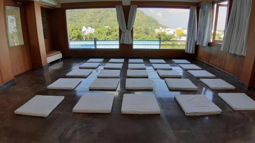 a room with a bunch of white cushions on the floor at Aishwarya Residency in Tiruvannāmalai