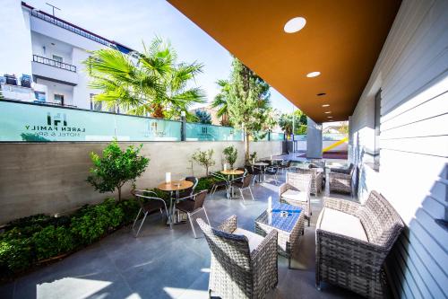 a patio with tables and chairs on a building at Laren Family Hotel & Spa - Boutique Class in Antalya
