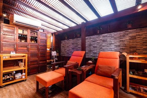 a tasting room with orange chairs and a skylight at Ipoh Bali Hotel in Ipoh