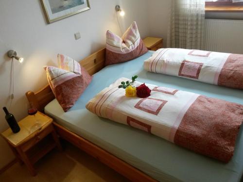 two beds with pillows on them in a bedroom at Heideggerhof in Bolzano