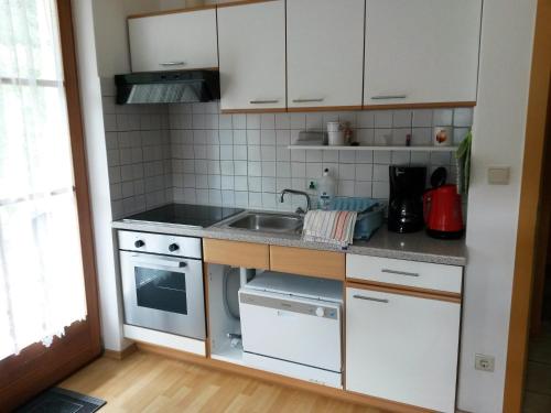 a small kitchen with a sink and a stove at Heideggerhof in Bolzano