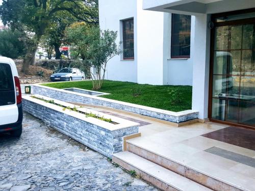 a house with stone steps leading to the front door at Berksoy Hotel in Bergama