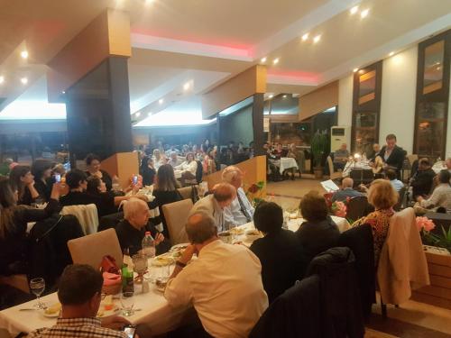 a group of people sitting at tables in a room at Berksoy Hotel in Bergama