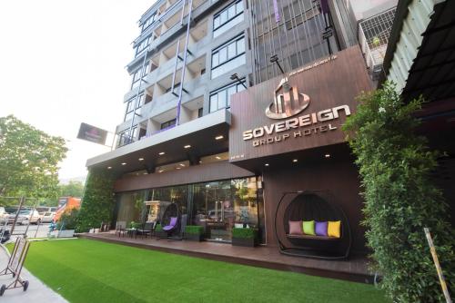 a store with a green lawn in front of it at Sovereign Group Hotel at Pratunam in Bangkok