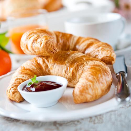 a plate of croissants and a bowl of jam at Hotel Königsteiner Hof in Königstein in der Oberpfalz