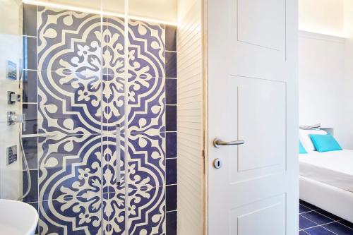 a bathroom with a shower with a white door at Palazzo Gentilcore in Castellabate