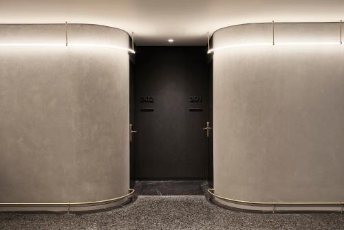 a hallway with two metal doors in a building at Perianth Hotel, a Member of Design Hotels in Athens