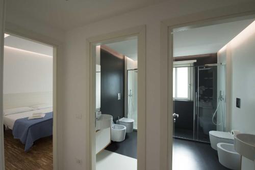 a bedroom with a bed and a bathroom with a sink at apARTments Sperlonga in Sperlonga