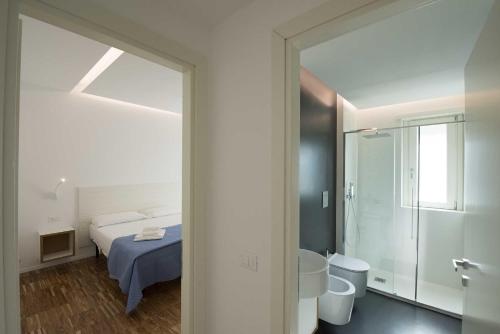a bedroom with a bed and a bathroom with a mirror at apARTments Sperlonga in Sperlonga