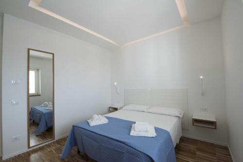 a bedroom with a bed with two towels on it at apARTments Sperlonga in Sperlonga