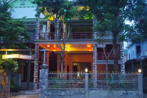 a building with a fence in front of it at Village House in Phong Nha