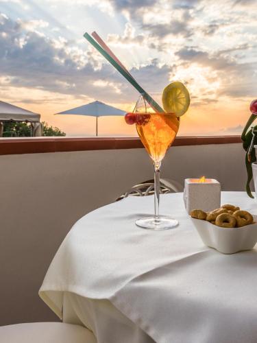 a drink sitting on a table with a bowl of food at B&B Villa Cristina in Anacapri