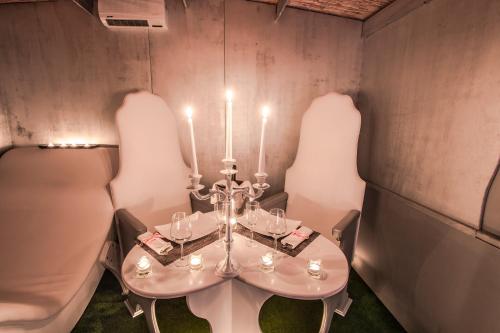 a dining room with a white table and chairs at Hotel Butterfly in Torre del Lago Puccini