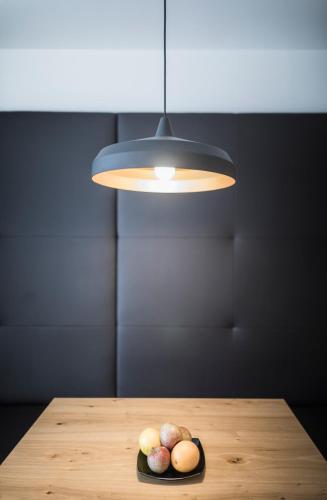 a table with a light and a plate of fruit at Residence Margareth in Campo Tures