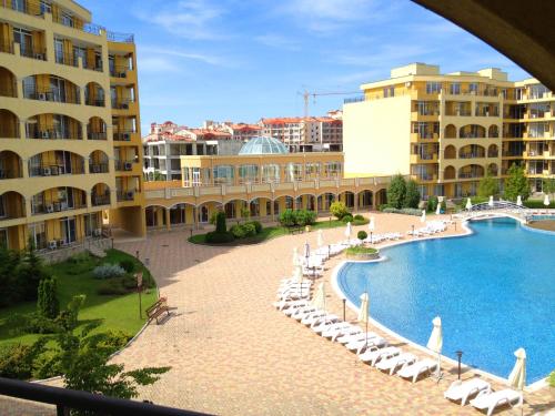 a resort with a swimming pool and chairs and buildings at PSB Apartments in Midia Resort Aheloy in Aheloy