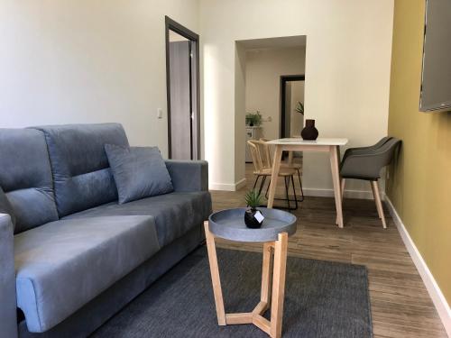 a living room with a couch and a table at Apartamentos AL-QAZERES LUXURY La Concepción in Cáceres