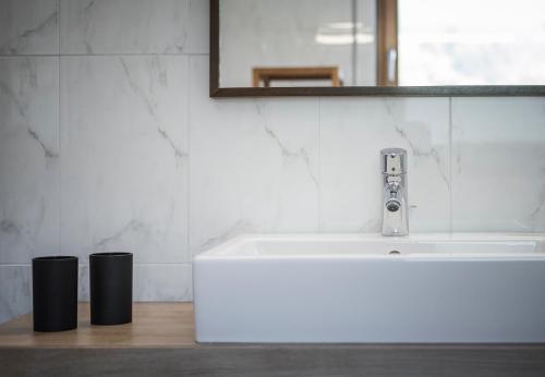 a bathroom with a white sink and a mirror at Residence Margareth in Campo Tures