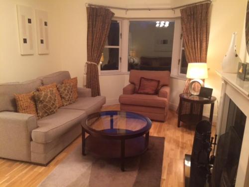 a living room with a couch and a coffee table at ArdMullen Townhouse X Davitt's Guesthouse & Restaurant Kenmare in Kenmare