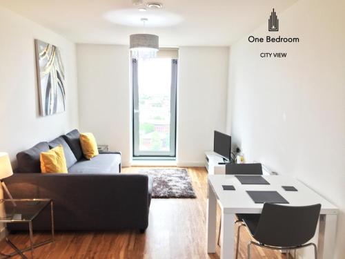 a living room with a couch and a table at Media City Salford Quays in Manchester