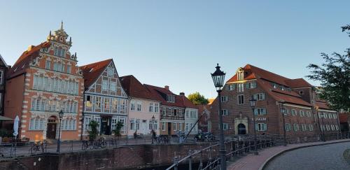 a group of buildings next to a canal in a city at Kiek In Hotel Zur Einkehr in Stade