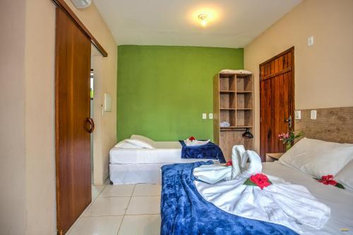 Un ou plusieurs lits dans un hébergement de l'établissement i9 Embaú Flats & Suites