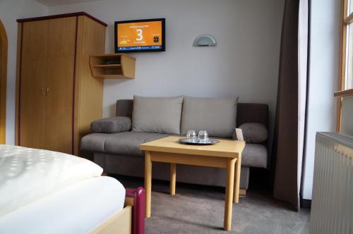 a living room with a couch and a table at Pension Strolz in Sankt Anton am Arlberg