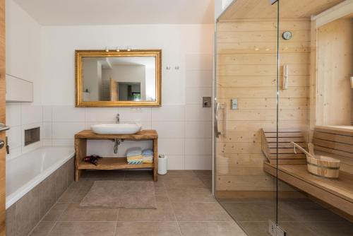 a bathroom with a sink and a shower at Naturchalet Höflehner in Ramsau am Dachstein