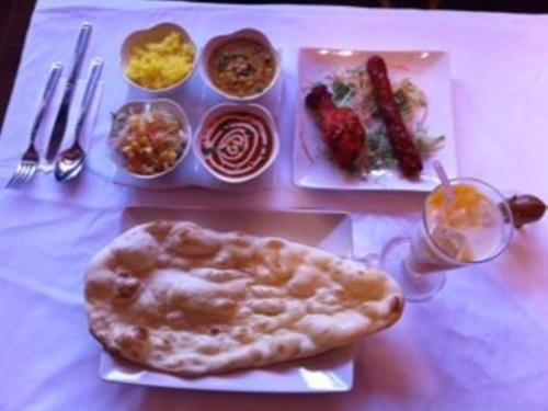 a table with a plate of food on a table at Fuji Gotemba Condominium Tannpopo in Gotemba