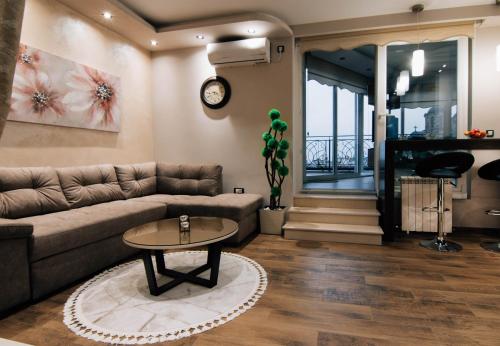 a living room with a couch and a table at President Lux in Belgrade