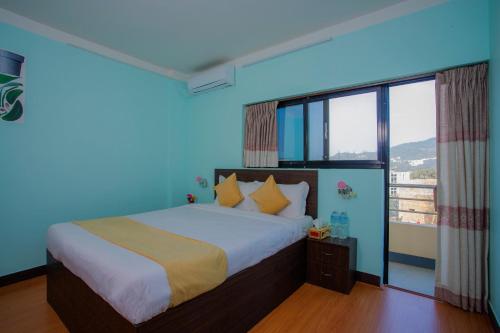 a bedroom with a large bed with a blue ceiling at Hotel Golden Three in Kathmandu