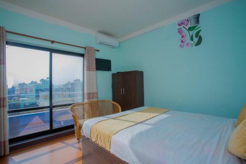 a bedroom with a bed and a large window at Hotel Golden Three in Kathmandu