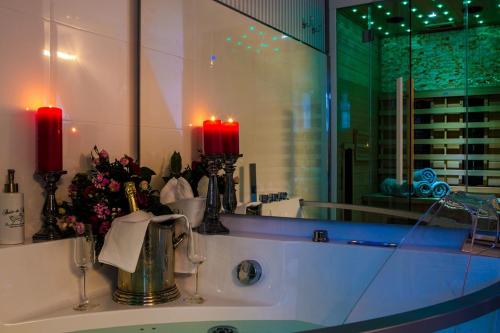 a bathroom sink with two candles and a mirror at Luxuslodge Wernigerode in Wernigerode