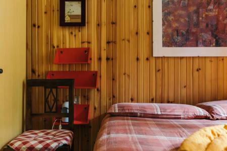 a bedroom with two beds and wood paneled walls at CENTRAL WOODEN CHALET WITH FOREST VIEW in Madonna di Campiglio