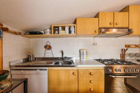 a kitchen with a sink and a stove at CENTRAL WOODEN CHALET WITH FOREST VIEW in Madonna di Campiglio