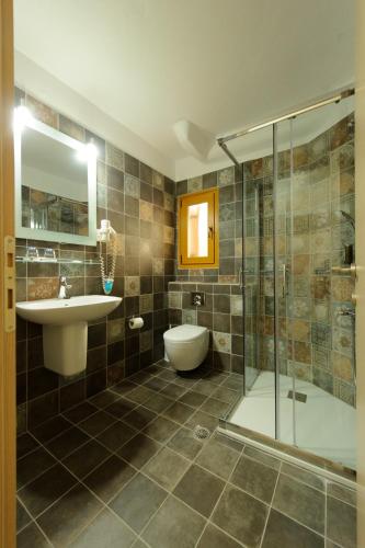 a bathroom with a sink toilet and a shower at Villa Coralli in Parga
