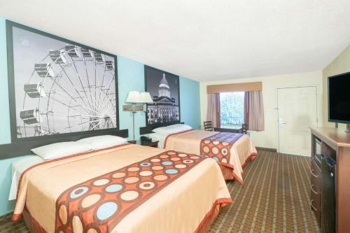 a hotel room with two beds and a ferris wheel at Super 8 by Wyndham North Little Rock/McCain in North Little Rock