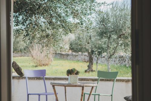 a table and four chairs sitting in front of a window at Pietra Pesara in Locorotondo