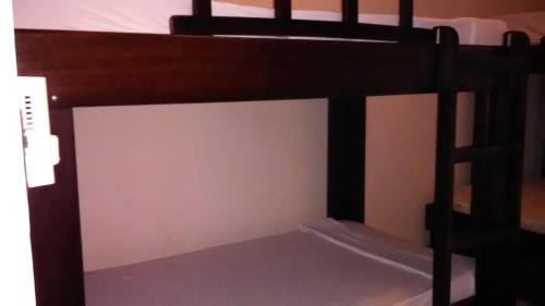 two bunk beds in a room with a white wall at Cabinas surf Arribadas in Playa Ostional