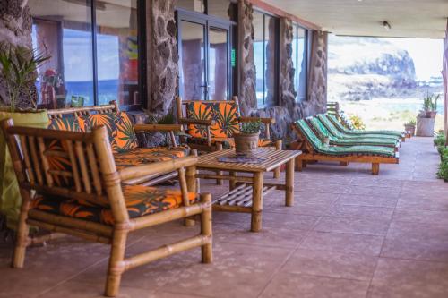 a group of chairs and tables in a room at Cabañas & Hostal Tojika in Hanga Roa