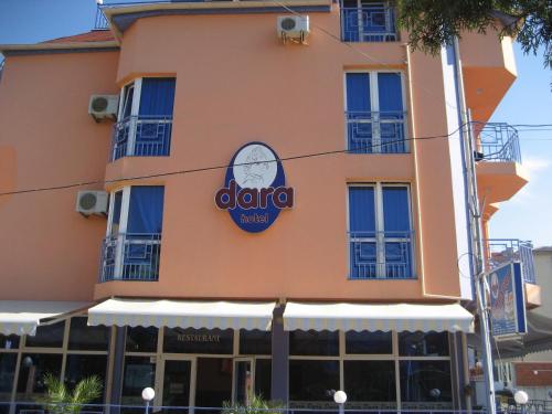 a building with a sign on the side of it at Dara Hotel in Primorsko