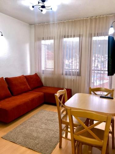 a living room with a couch and a table at Villa La Kola Krusevo in Kruševo