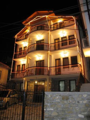a large white building with balconies on top of it at Villa La Kola Krusevo in Kruševo
