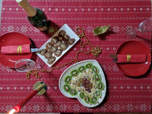 a table with a plate of food and a bottle of wine at Nikolo Inn in Stepantsminda