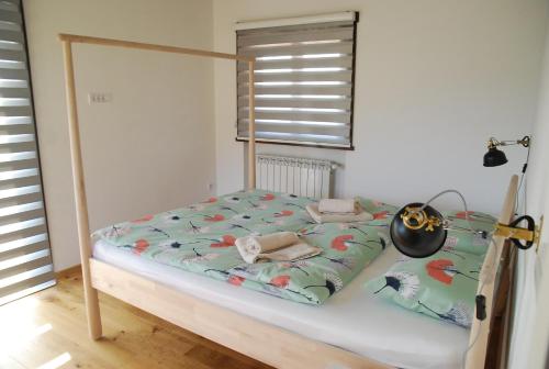 a bedroom with a bed with a canopy and a window at Wass House in Kosjerić