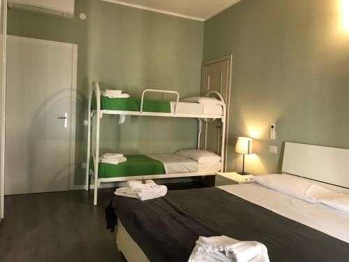 Postel nebo postele na pokoji v ubytování L'Arena Residence